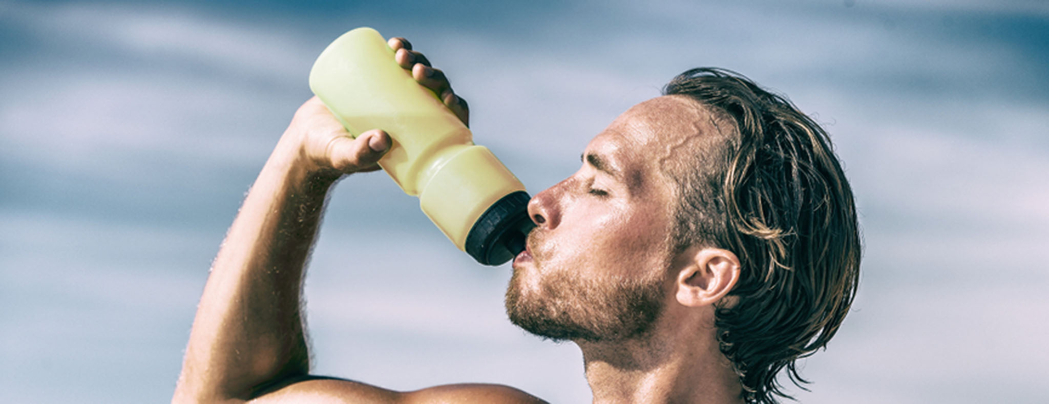 Sweating men drinking water 