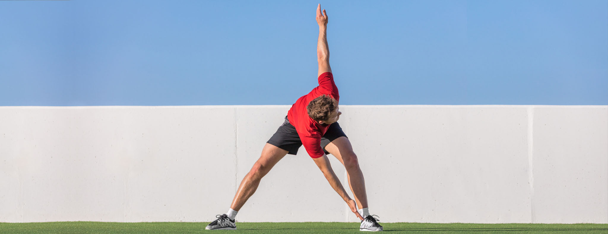 Men in red shirt stretching outdoor 